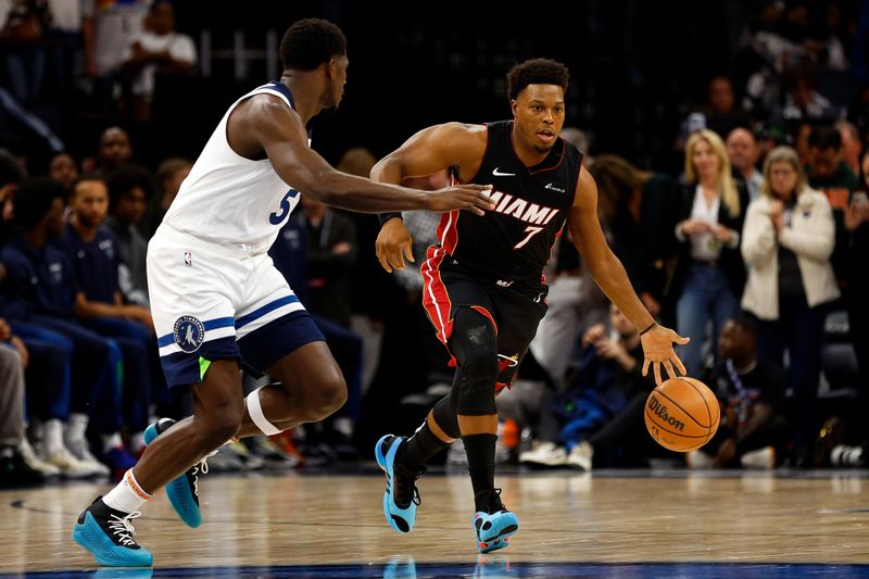 MINNEAPOLIS, MINNESOTA - OCTOBER 28: Kyle Lowry #7 of the Miami Heat dribbles the ball while Anthony Edwards #5 of the Minnesota Timberwolves defends in the first quarter at Target Center on October 28, 2023 in Minneapolis, Minnesota. NOTE TO USER: User expressly acknowledges and agrees that, by downloading and or using this photograph, User is consenting to the terms and conditions of the Getty Images License Agreement. (Photo by David Berding/Getty Images)