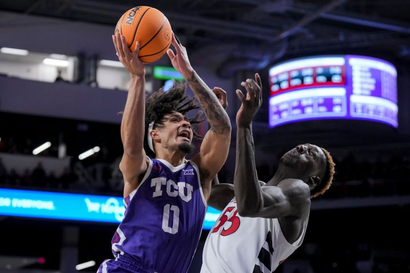 Jan 16, 2024; Cincinnati, Ohio, USA;  TCU Horned Frogs guard Micah Peavy (0) drives to the basket as he is fouled by Cincinnati Bearcats forward Aziz Bandaogo (55) in the second half at Fifth Third Arena. Mandatory Credit: Aaron Doster-USA TODAY Sports