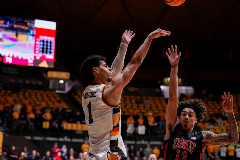 Feb 27, 2024; Laramie, Wyoming, USA; Wyoming Cowboys guard Brendan Wenzel (1) shoots against UNLV Runnin' Rebels guard Brooklyn Hicks (13) during overtime at Arena-Auditorium. Mandatory Credit: Troy Babbitt-USA TODAY Sports