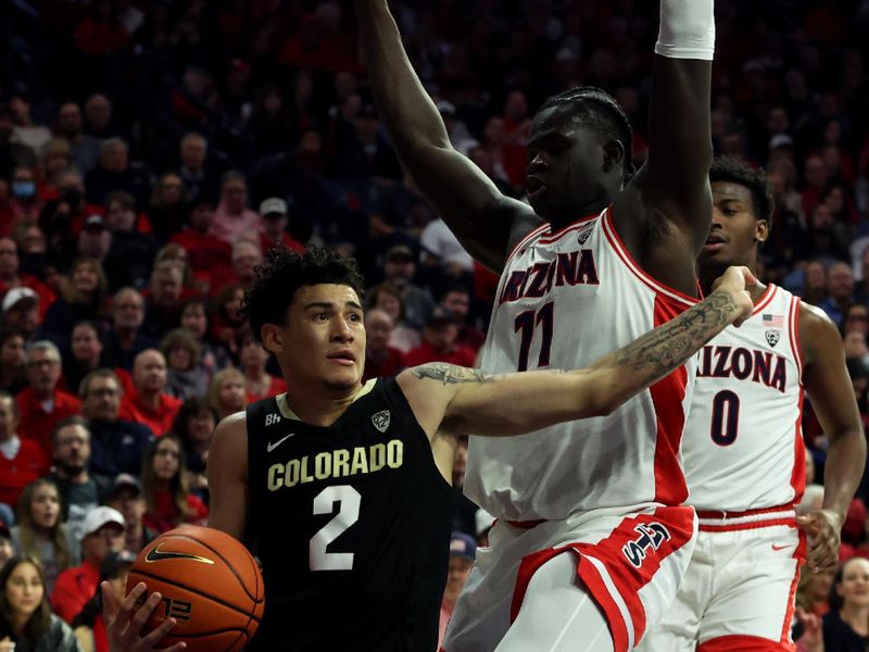 Jan 4, 2024; Tucson, Arizona, USA; Colorado Buffaloes guard KJ Simpson (2) drives to the net against Arizona Wildcats center Oumar Ballo (11) during the first half at McKale Center. Mandatory Credit: Zachary BonDurant-USA TODAY Sports