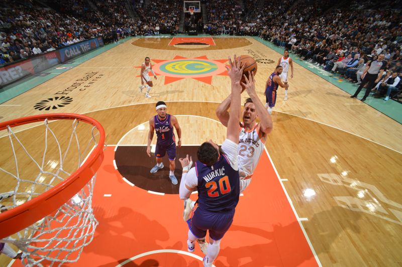 SAN ANTONIO, TX - MARCH 25: Jusuf Nurkic #20 of the Phoenix Suns blocks Zach Collins #23 of the San Antonio Spurs during the game on March 25, 2024 at the AT&T Center in San Antonio, Texas. NOTE TO USER: User expressly acknowledges and agrees that, by downloading and or using this photograph, user is consenting to the terms and conditions of the Getty Images License Agreement. Mandatory Copyright Notice: Copyright 2024 NBAE (Photos by Jesse D. Garrabrant/NBAE via Getty Images)