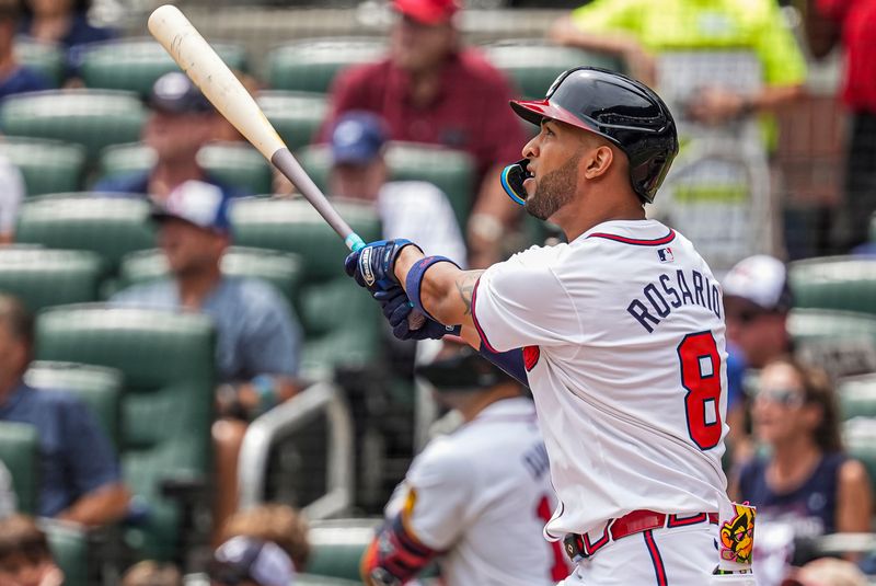 Jul 20, 2024; Cumberland, GA, USA; Atlanta Braves left fielder Eddie Rosario (8) hits a two run game tying home run against the St. Louis Cardinals during the seventh inning at Truist Park. Mandatory Credit: Dale Zanine-USA TODAY Sports