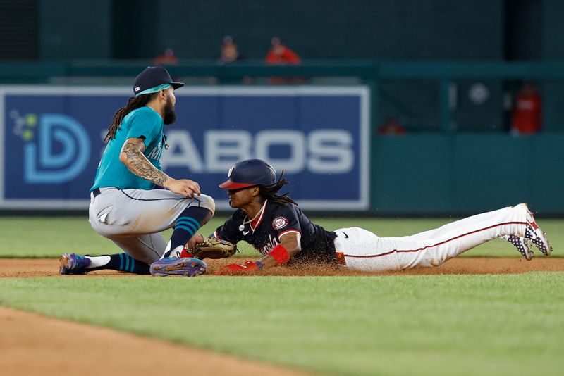 May 24, 2024; Washington, District of Columbia, USA; Washington Nationals shortstop CJ Abrams (5) is tagged out by Seattle Mariners shortstop J.P. Crawford (3) attempting to steal second base during the seventh inning at Nationals Park. Mandatory Credit: Geoff Burke-USA TODAY Sports