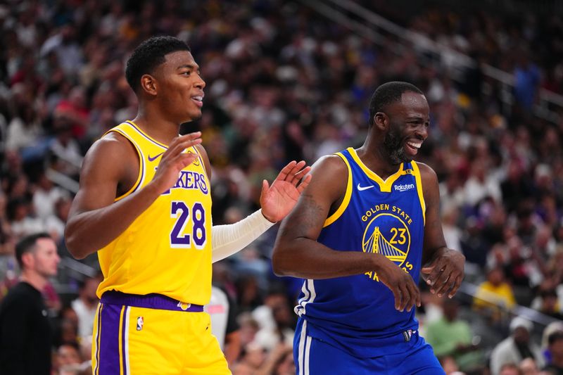 LAS VEGAS, NV - OCTOBER 15: Rui Hachimura #28 of the Los Angeles Lakers and Draymond Green #23 of the Golden State Warriors smile during the game during the 2024 NBA Preseason on October 15, 2024 at T-Mobile Arena in Las Vegas, Nevada. NOTE TO USER: User expressly acknowledges and agrees that, by downloading and or using this photograph, User is consenting to the terms and conditions of the Getty Images License Agreement. Mandatory Copyright Notice: Copyright 2024 NBAE  (Photo by Jeff Bottari/NBAE via Getty Images)