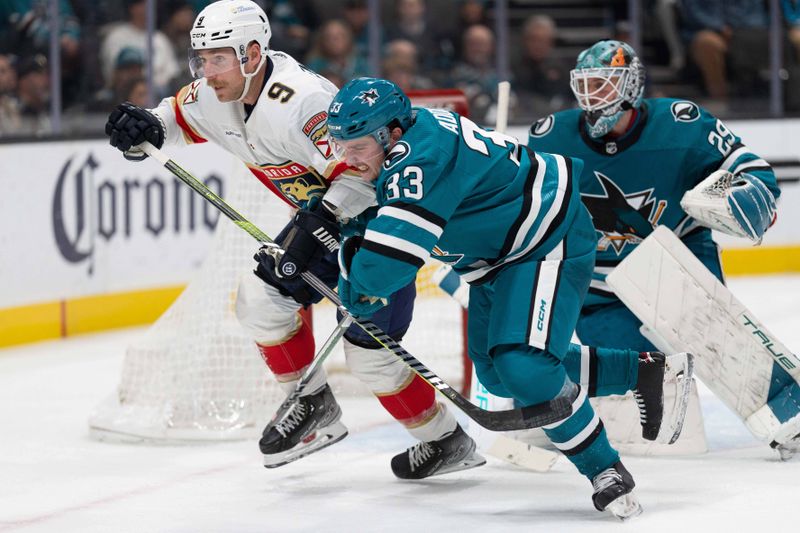 Nov 14, 2023; San Jose, California, USA; Florida Panthers center Sam Bennett (9) and San Jose Sharks defenseman Calen Addison (33) chase after the puck during the third period at SAP Center at San Jose. Mandatory Credit: Stan Szeto-USA TODAY Sports