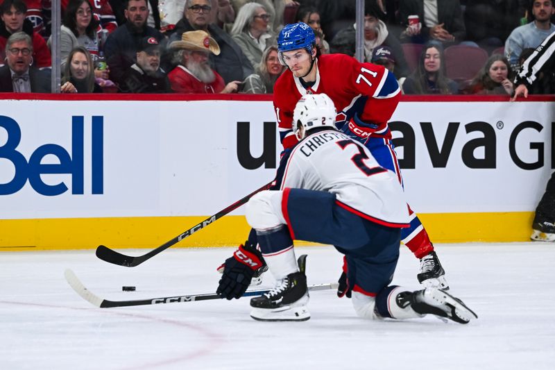 Nov 16, 2024; Montreal, Quebec, CAN; Columbus Blue Jackets defenseman Jake Christiansen (2) defends the puck against Montreal Canadiens center Jake Evans (71)  during the second period at Bell Centre. Mandatory Credit: David Kirouac-Imagn Images