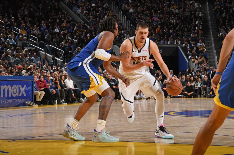 SAN FRANCISCO, CA - JANUARY 4: Nikola Jokic #15 of the Denver Nuggets dribbles the ball during the game against the Golden State Warriors on January 4, 2024 at Chase Center in San Francisco, California. NOTE TO USER: User expressly acknowledges and agrees that, by downloading and or using this photograph, user is consenting to the terms and conditions of Getty Images License Agreement. Mandatory Copyright Notice: Copyright 2024 NBAE (Photo by Noah Graham/NBAE via Getty Images)