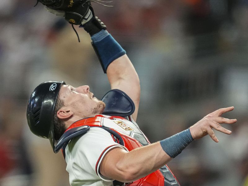 Aug 15, 2023; Cumberland, Georgia, USA; Atlanta Braves catcher Sean Murphy (12) catches a pop up against the New York Yankees during the seventh inning at Truist Park. Mandatory Credit: Dale Zanine-USA TODAY Sports