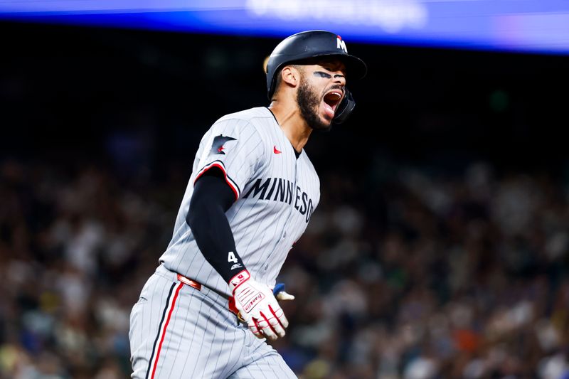 May 30, 2025; Seattle, Washington, USA; Minnesota Twins shortstop Carlos Correa (4) celebrates after hitting a two-run home run against the Seattle Mariners during the tenth inning at T-Mobile Park. Mandatory Credit: Joe Nicholson-Imagn Images