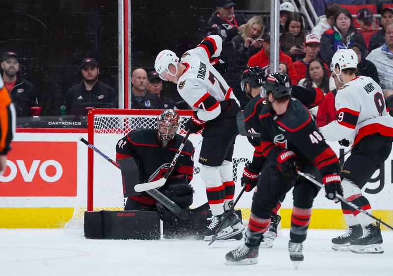 Nov 16, 2024; Raleigh, North Carolina, USA;  Carolina Hurricanes goaltender Frederik Andersen (31) stops the tip shot attempt by Ottawa Senators left wing Brady Tkachuk (7) during the third period at Lenovo Center. Mandatory Credit: James Guillory-Imagn Images