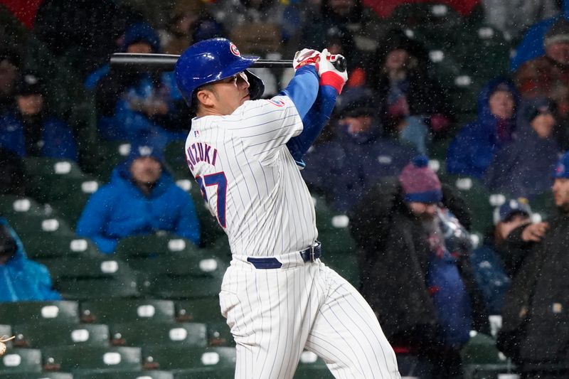 Apr 3, 2024; Chicago, Illinois, USA; Chicago Cubs right fielder Seiya Suzuki (27) hits a home run against the Colorado Rockies during the fifth inning at Wrigley Field. Mandatory Credit: David Banks-USA TODAY Sports