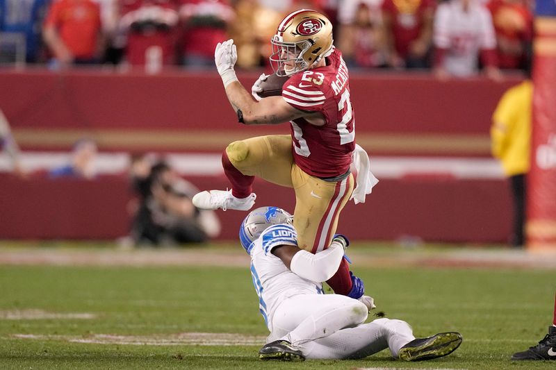 San Francisco 49ers running back Christian McCaffrey (23) runs against Detroit Lions safety Kerby Joseph during the second half of the NFC Championship NFL football game in Santa Clara, Calif., Sunday, Jan. 28, 2024. (AP Photo/Mark J. Terrill)