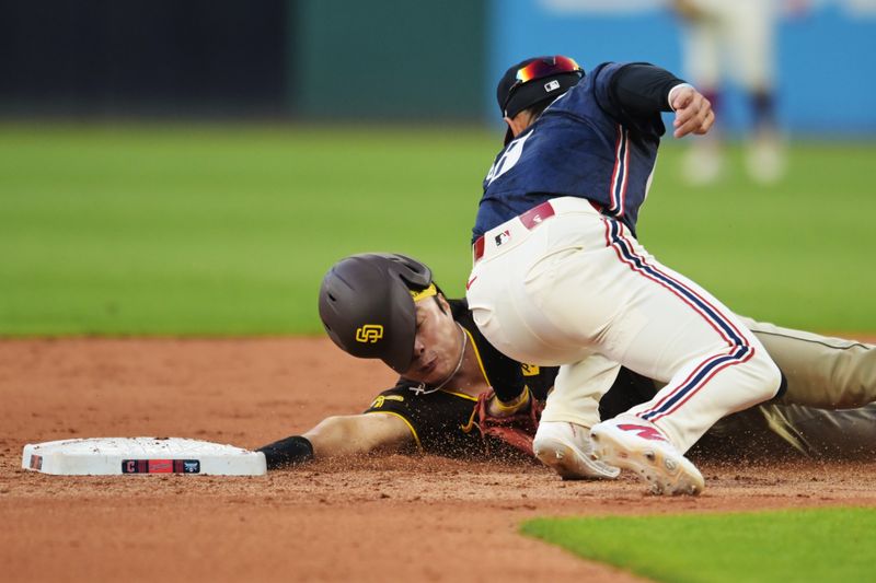 Jul 19, 2024; Cleveland, Ohio, USA; Cleveland Guardians second baseman Andres Gimenez (0) tags out San Diego Padres shortstop Ha-Seong Kim (7) during the fifth inning at Progressive Field. Mandatory Credit: Ken Blaze-USA TODAY Sports