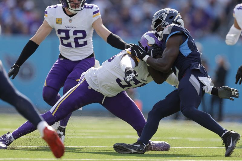 Minnesota Vikings outside linebacker Jonathan Greenard (58) tackles Tennessee Titans running back Tyjae Spears (2) during the first half of an NFL football game, Sunday, Nov. 17, 2024, in Nashville, Tenn. (AP Photo/Stew Milne)