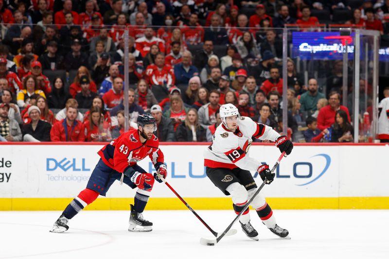 Feb 26, 2024; Washington, District of Columbia, USA; Ottawa Senators right wing Drake Batherson (19) passes the puck as Washington Capitals right wing Tom Wilson (43) defends in the second period at Capital One Arena. Mandatory Credit: Geoff Burke-USA TODAY Sports