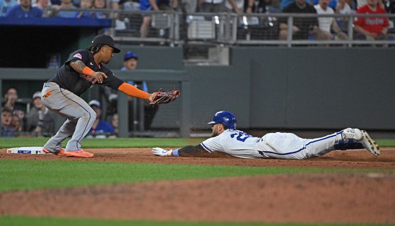 Jun 27, 2024; Kansas City, Missouri, USA;  Kansas City Royals center fielder Kyle Isbel (28) dives into third base with a lead off triple against Cleveland Guardians third baseman Jose Ramirez (11) in the sixth inning at Kauffman Stadium. Mandatory Credit: Peter Aiken-USA TODAY Sports