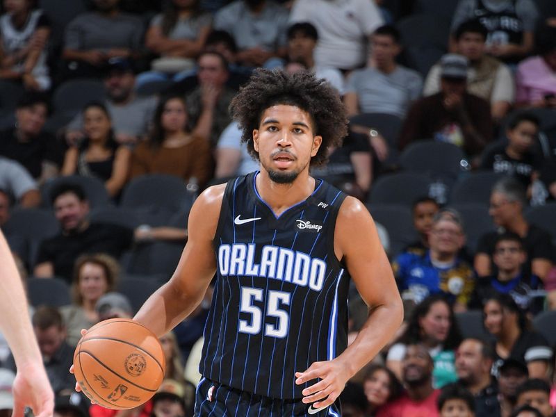 SAN ANTONIO, TX - OCTOBER 9: Ethan Thompson #55 of the Orlando Magic dribbles the ball during the game against the San Antonio Spurs during a NBA preseason game on October 9, 2024 at the Frost Bank Center in San Antonio, Texas. NOTE TO USER: User expressly acknowledges and agrees that, by downloading and or using this photograph, user is consenting to the terms and conditions of the Getty Images License Agreement. Mandatory Copyright Notice: Copyright 2024 NBAE (Photos by Michael Gonzales/NBAE via Getty Images)