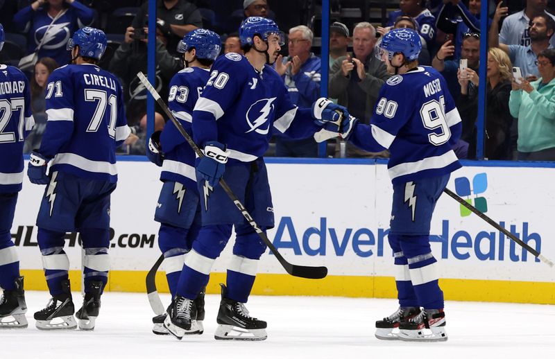 Nov 14, 2024; Tampa, Florida, USA; Tampa Bay Lightning left wing Nick Paul (20) and Tampa Bay Lightning defenseman J.J. Moser (90) celebrate after they beat the Winnipeg Jets at Amalie Arena. Mandatory Credit: Kim Klement Neitzel-Imagn Images