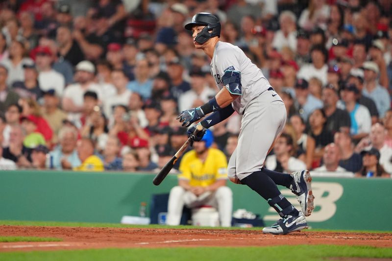 Jul 27, 2024; Boston, Massachusetts, USA; <p><br/></p>New York Yankees designated hitter Aaron Judge (99) runs out an RBI single against the Boston Red Sox during the fifth inning at Fenway Park. Mandatory Credit: Gregory Fisher-USA TODAY Sports