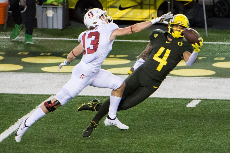 Nov 7, 2020; Eugene, Oregon, USA; Oregon Ducks wide receiver Mycah Pittman (4) catches a pass against Stanford Cardinal cornerback Ethan Bonner (13) during the first half at Autzen Stadium. Mandatory Credit: Troy Wayrynen-USA TODAY Sports