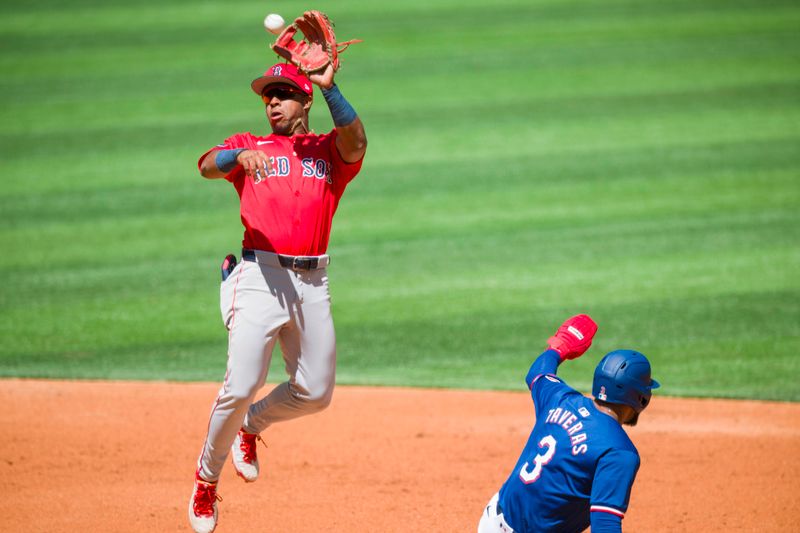 Mar 26, 2024; Arlington, Texas, USA; Texas Rangers center fielder Leody Taveras (3) steals second as Boston Red Sox second baseman Enmanuel Valdez (47) fields the high throw during the second inning at Globe Life Field. Mandatory Credit: Jerome Miron-USA TODAY Sports