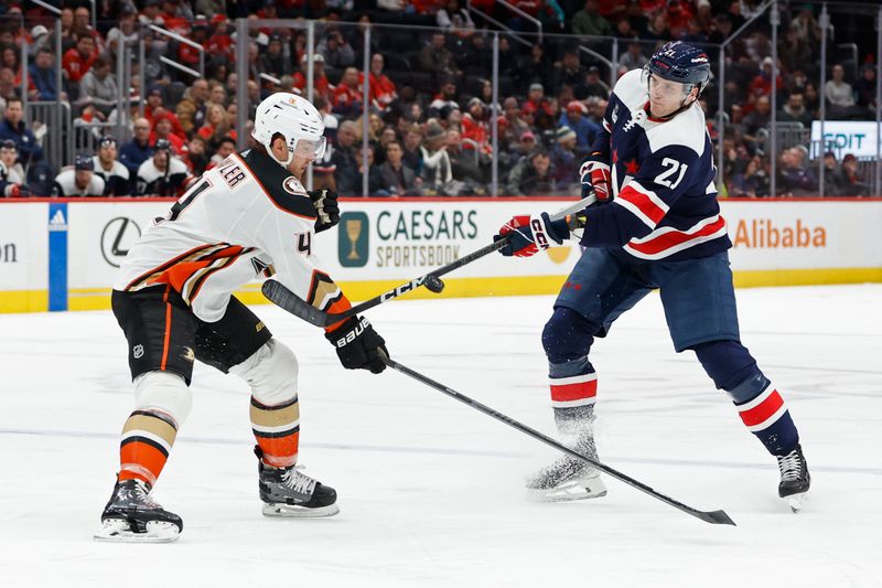 Jan 16, 2024; Washington, District of Columbia, USA; Anaheim Ducks defenseman Cam Fowler (4) deflects a shot by Washington Capitals center Aliaksei Protas (21) in the third period at Capital One Arena. Mandatory Credit: Geoff Burke-USA TODAY Sports