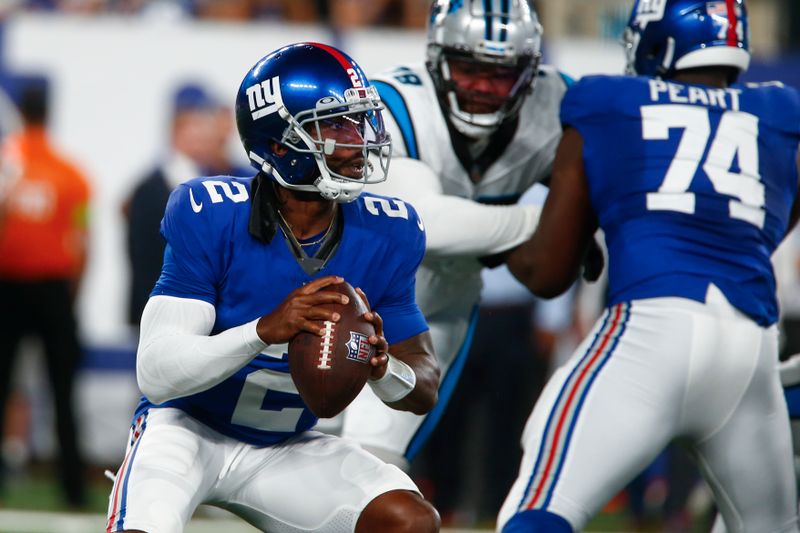 New York Giants quarterback Tyrod Taylor, left, looks to throw during the first half of an NFL preseason football game against the Carolina Panthers, Friday, Aug. 18, 2023, in East Rutherford, N.J. (AP Photo/John Munson)