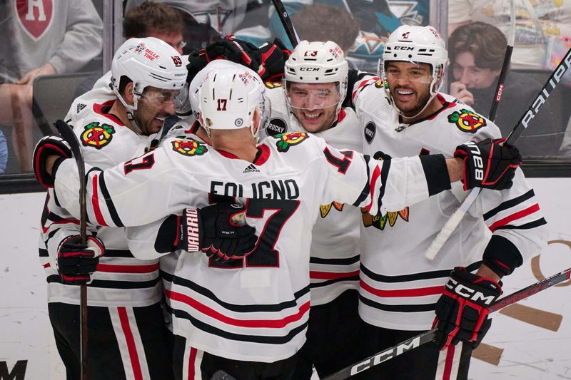 Mar 23, 2024; San Jose, California, USA; Chicago Blackhawks center Philipp Kurashev (23) celebrates with defenseman Seth Jones (4), left wing Nick Foligno (17) and center Andreas Athanasiou (89) after scoring the game-tying goal against the San Jose Sharks during the third period at SAP Center at San Jose. Mandatory Credit: Robert Edwards-USA TODAY Sports