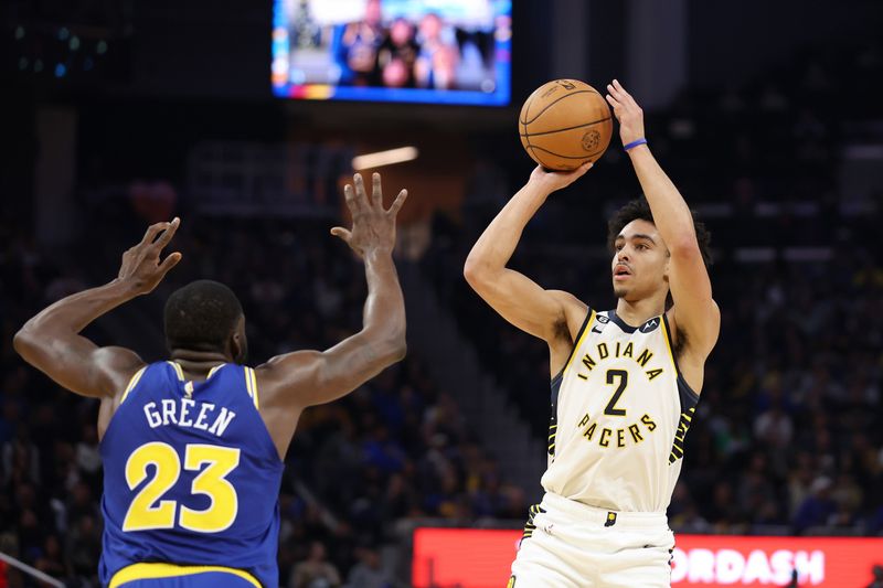 SAN FRANCISCO, CALIFORNIA - DECEMBER 05: Andrew Nembhard #2 of the Indiana Pacers shoots over Draymond Green #23 of the Golden State Warriors at Chase Center on December 05, 2022 in San Francisco, California. NOTE TO USER: User expressly acknowledges and agrees that, by downloading and or using this photograph, User is consenting to the terms and conditions of the Getty Images License Agreement.  (Photo by Ezra Shaw/Getty Images)