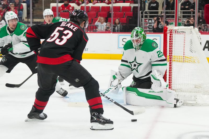 Jan 6, 2026; Raleigh, North Carolina, USA;  Carolina Hurricanes right wing Jackson Blake (53) skates with the puck in front of Dallas Stars goaltender Jake Oettinger (29) during the first period at Lenovo Center. Mandatory Credit: James Guillory-Imagn Images