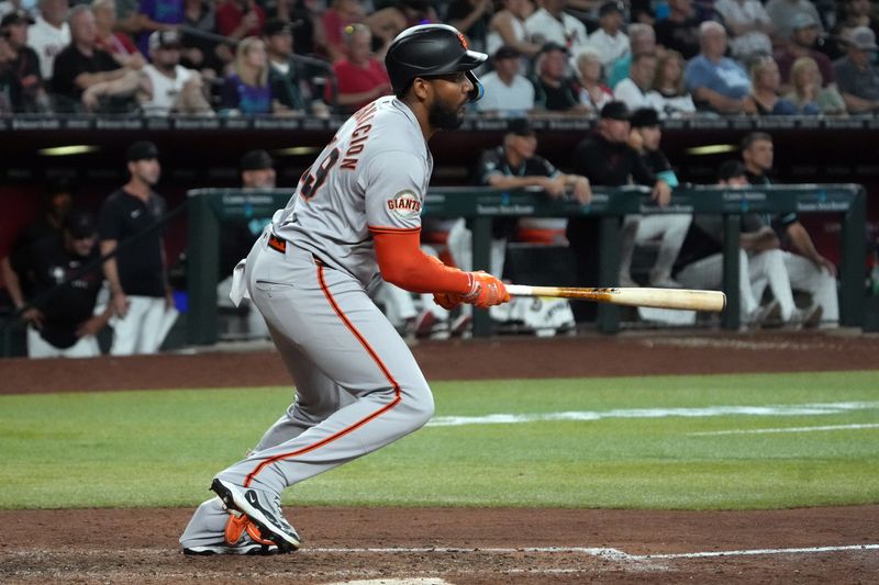 Sep 17, 2025; Phoenix, Arizona, USA; San Francisco Giants outfielder Jerar Encarnacion (59) hits an RBI single against the Arizona Diamondbacks in the eleventh inning at Chase Field. Mandatory Credit: Rick Scuteri-Imagn Images