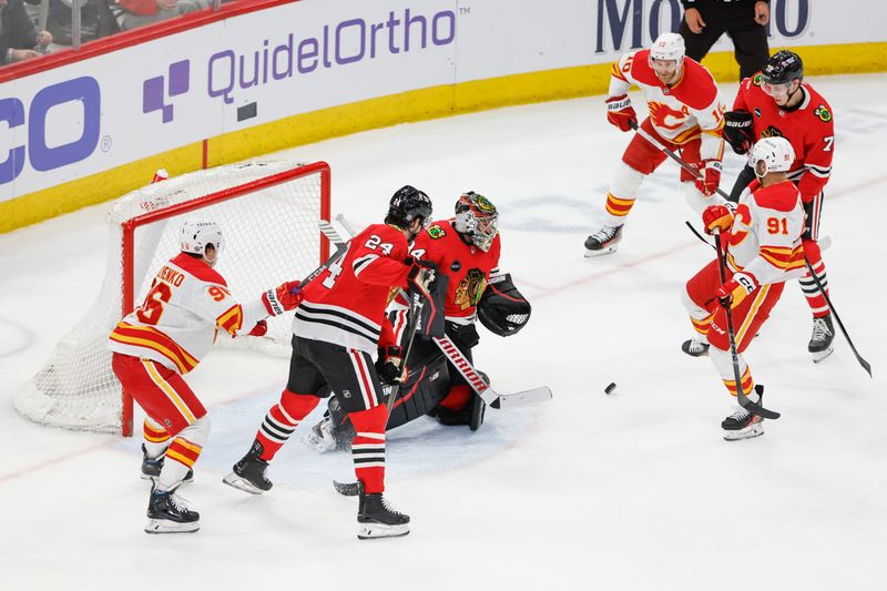 Mar 26, 2024; Chicago, Illinois, USA; Chicago Blackhawks goaltender Petr Mrazek (34) defends against the Calgary Flames during the second period at United Center. Mandatory Credit: Kamil Krzaczynski-USA TODAY Sports