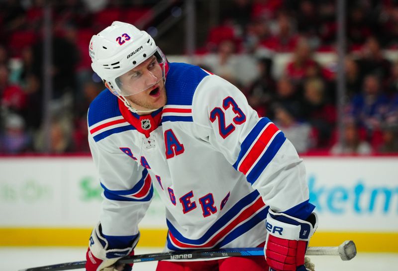 Mar 12, 2024; Raleigh, North Carolina, USA; New York Rangers defenseman Adam Fox (23) reacts against the Carolina Hurricanes during the first period at PNC Arena. Mandatory Credit: James Guillory-USA TODAY Sports