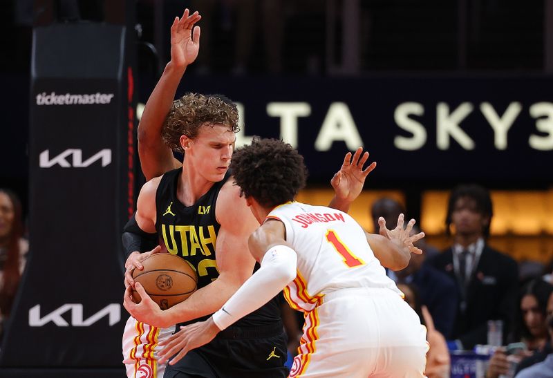 ATLANTA, GEORGIA - FEBRUARY 27:  Lauri Markkanen #23 of the Utah Jazz is defended by Jalen Johnson #1 and De'Andre Hunter #12 of the Atlanta Hawks during the second quarter at State Farm Arena on February 27, 2024 in Atlanta, Georgia.  NOTE TO USER: User expressly acknowledges and agrees that, by downloading and/or using this photograph, user is consenting to the terms and conditions of the Getty Images License Agreement.  (Photo by Kevin C. Cox/Getty Images)