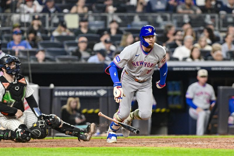 May 16, 2025; Bronx, New York, USA; New York Mets outfielder Brandon Nimmo (9) hits a double against the New York Yankees during the sixth inning at Yankee Stadium. Mandatory Credit: John Jones-Imagn Images