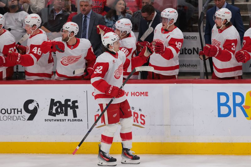 Jan 16, 2025; Sunrise, Florida, USA; Detroit Red Wings center Marco Kasper (92) celebrates with teammates after scoring against the Florida Panthers during the second period at Amerant Bank Arena. Mandatory Credit: Sam Navarro-Imagn Images