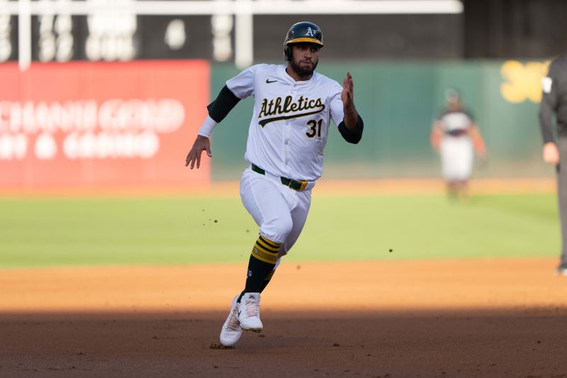 Jun 21, 2024; Oakland, California, USA; Oakland Athletics third base Abraham Toro (31) runs towards third base against the Minnesota Twins during the first inning at Oakland-Alameda County Coliseum. Mandatory Credit: Stan Szeto-USA TODAY Sports