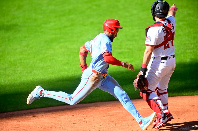Jun 28, 2025; Cleveland, Ohio, USA; St. Louis Cardinals center fielder Victor Scott II (11) scores beside Cleveland Guardians catcher Austin Hedges (27) in the sixth inning at Progressive Field. Mandatory Credit: David Richard-Imagn Images