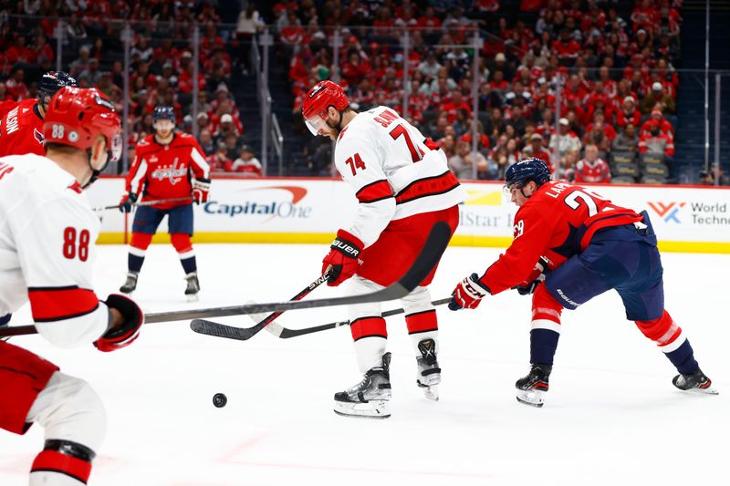 Mar 22, 2024; Washington, District of Columbia, USA; Carolina Hurricanes defenseman Jaccob Slavin (74) watches the puck in front of Washington Capitals center Hendrix Lapierre (29) during the second period at Capital One Arena. Mandatory Credit: Amber Searls-USA TODAY Sports