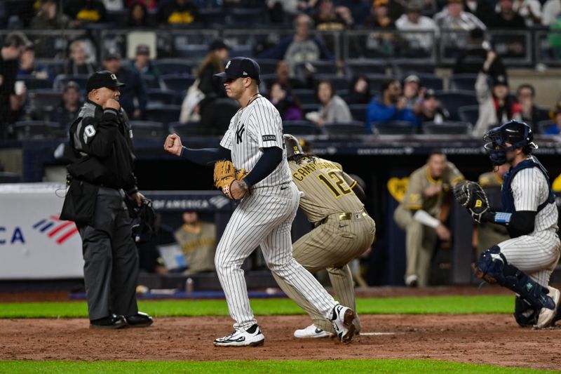 May 5, 2025; Bronx, New York, USA; New York Yankees pitcher Fernando Cruz (63) reacts as San Diego Padres catcher Luis Campusano (12) is tagged out at home by catcher Austin Wells (28) during the seventh inning at Yankee Stadium. Mandatory Credit: John Jones-Imagn Images