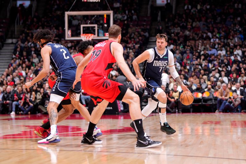 TORONTO, CANADA - FEBRUARY 28: Luka Doncic #77 of the Dallas Mavericks handles the ball during the game against the Toronto Raptors on February 28, 2024 at the Scotiabank Arena in Toronto, Ontario, Canada.  NOTE TO USER: User expressly acknowledges and agrees that, by downloading and or using this Photograph, user is consenting to the terms and conditions of the Getty Images License Agreement.  Mandatory Copyright Notice: Copyright 2024 NBAE (Photo by Mark Blinch/NBAE via Getty Images)