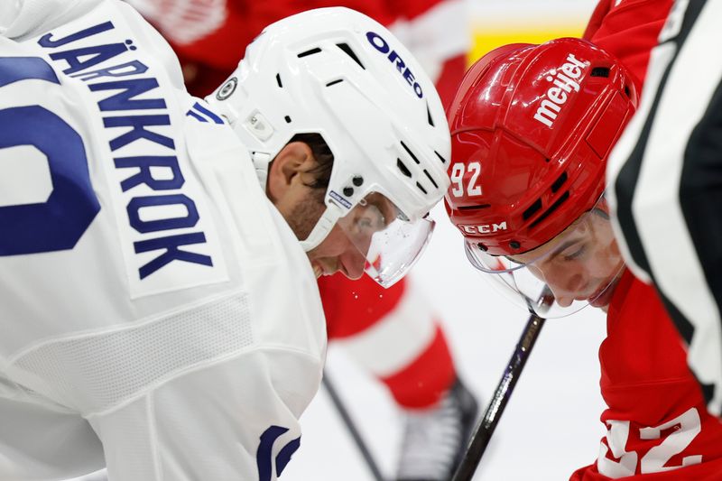 Oct 3, 2024; Detroit, Michigan, USA; Detroit Red Wings center Marco Kasper (92) and Toronto Maple Leafs center Calle Jarnkrok (19) face off in the second period at Little Caesars Arena. Mandatory Credit: Rick Osentoski-Imagn Images