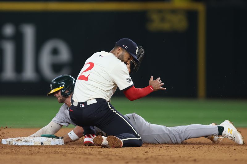 Aug 30, 2024; Arlington, Texas, USA; Oakland Athletics third base Max Schuemann (12) steals second base as Texas Rangers second base Marcus Semien (2) catches the throw in the ninth inning at Globe Life Field. Mandatory Credit: Tim Heitman-USA TODAY Sports