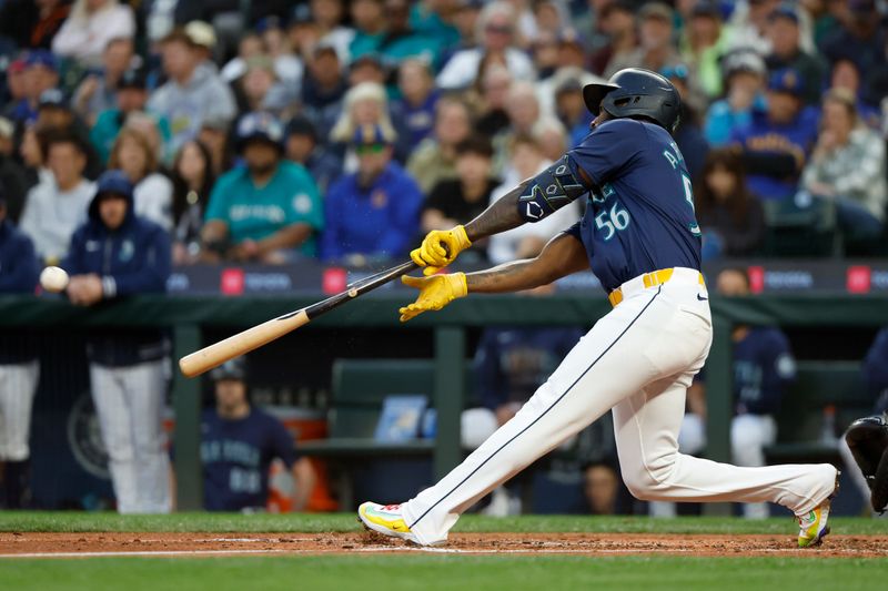 Aug 27, 2024; Seattle, Washington, USA; Seattle Mariners left fielder Randy Arozarena (56) breaks his bat while hitting a single against the Tampa Bay Rays during the fourth inning at T-Mobile Park. Mandatory Credit: Joe Nicholson-USA TODAY Sports