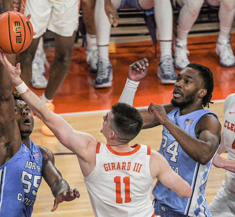 Jan 6, 2024; Clemson, South Carolina, USA; Clemson graduate Joseph Girard III  scores near University of North Carolina forward Jae'Lyn Withers (24) during the first half at Littlejohn Coliseum. Mandatory Credit: Ken Ruinard-USA TODAY Sports