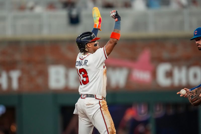 Sep 27, 2023; Cumberland, Georgia, USA; Atlanta Braves right fielder Ronald Acuna Jr. (13) reacts after stealing his 70th base of the season against the Chicago Cubs during the tenth inning at Truist Park. Mandatory Credit: Dale Zanine-USA TODAY Sports