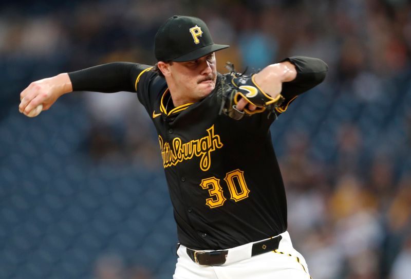 Jun 17, 2024; Pittsburgh, Pennsylvania, USA;  Pittsburgh Pirates starting pitcher Paul Skenes (30) delivers a pitch against the Cincinnati Reds during the first inning at PNC Park. Mandatory Credit: Charles LeClaire-USA TODAY Sports