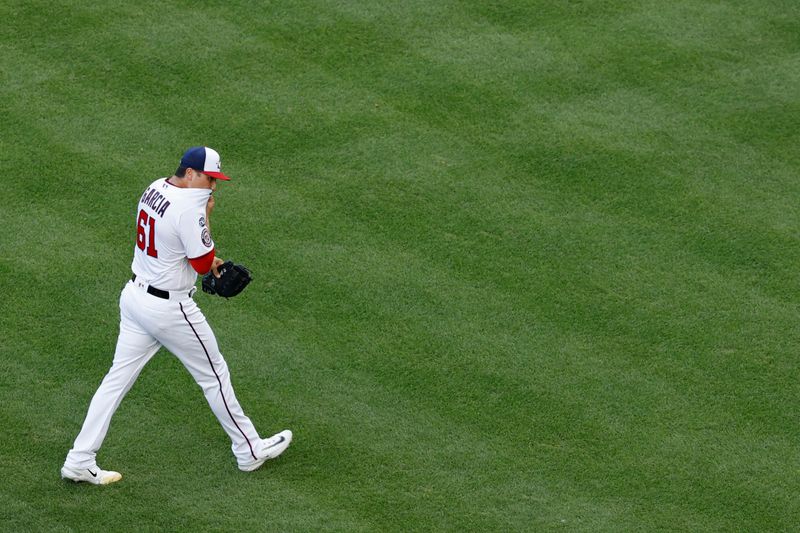 Aug 17, 2023; Washington, District of Columbia, USA; Washington Nationals relief pitcher Robert Garcia (61) walks off the field after being removed from the game against the Boston Red Sox during the seventh inning at Nationals Park. Mandatory Credit: Geoff Burke-USA TODAY Sports