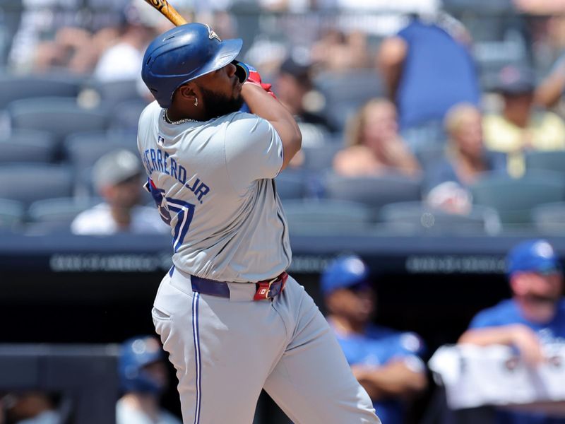 Aug 3, 2024; Bronx, New York, USA; Toronto Blue Jays first baseman Vladimir Guerrero Jr. (27) follows through on a solo home run against the New York Yankees during the first inning at Yankee Stadium. Mandatory Credit: Brad Penner-USA TODAY Sports