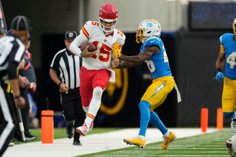 Kansas City Chiefs quarterback Patrick Mahomes (15) is pushed out of bounds by Los Angeles Chargers cornerback Asante Samuel Jr. (26) during the second half of an NFL football game Sunday, Sept. 29, 2024, in Inglewood, Calif. (AP Photo/Ashley Landis)